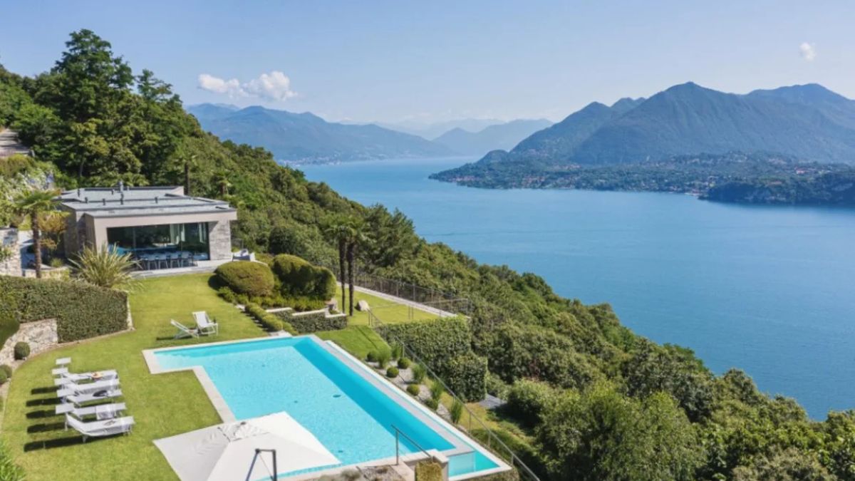 View over lake Como Italy with luxury villa with private pool in the foreground